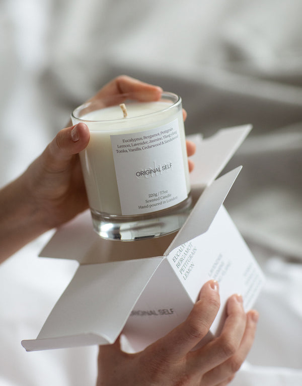 a person unboxing the Original Self - Calm candle.