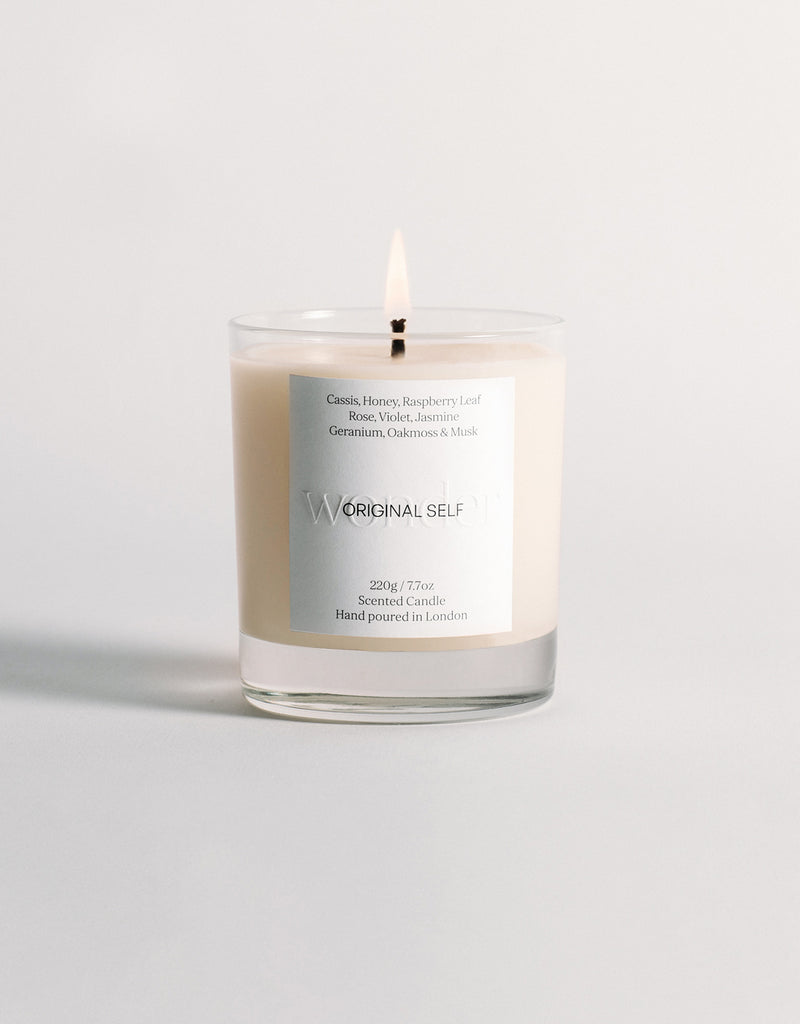 A lit product shot of the Original Self Wonder scented candle.